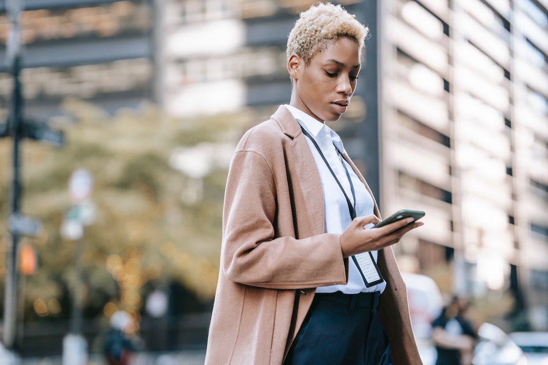Foto di una donna in città che guarda il cellulare - Foto di Ono Kosuki - Pexels